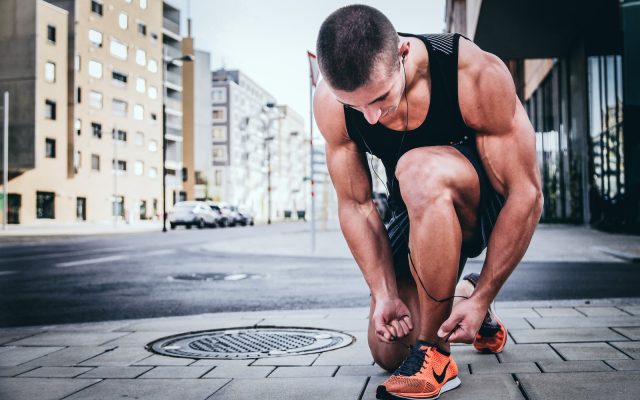 motivation - man tying his shoes